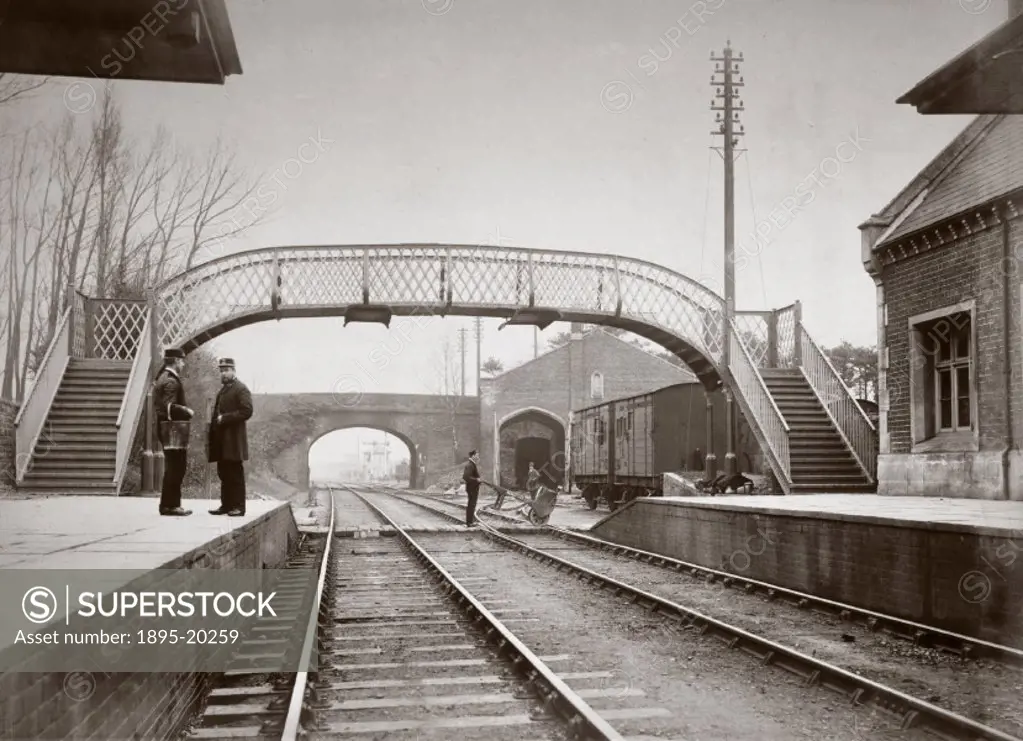 View of Yate station on the Midland & Great Western´s joint line through Gloucestershire, showing guards standing on the platform in front of a footbr...