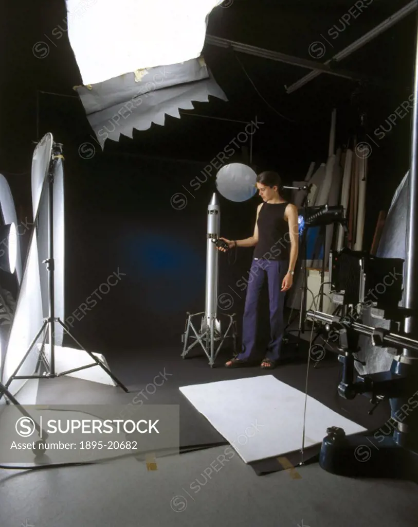 Science Museum photographer Claire Richardson preparing an object for photography in the Photo Studio, Science Museum, London.
