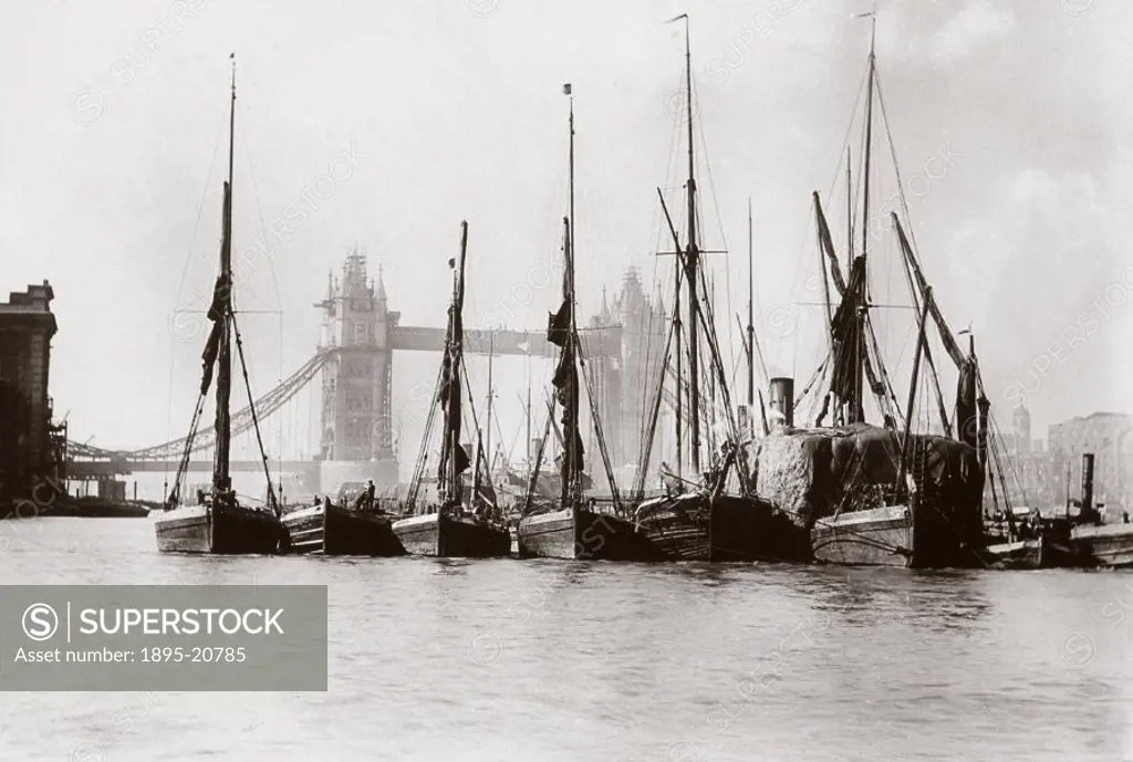 Photograph by Colonel Gale, showing a row of boats moored on the Thames with Tower Bridge in the background.