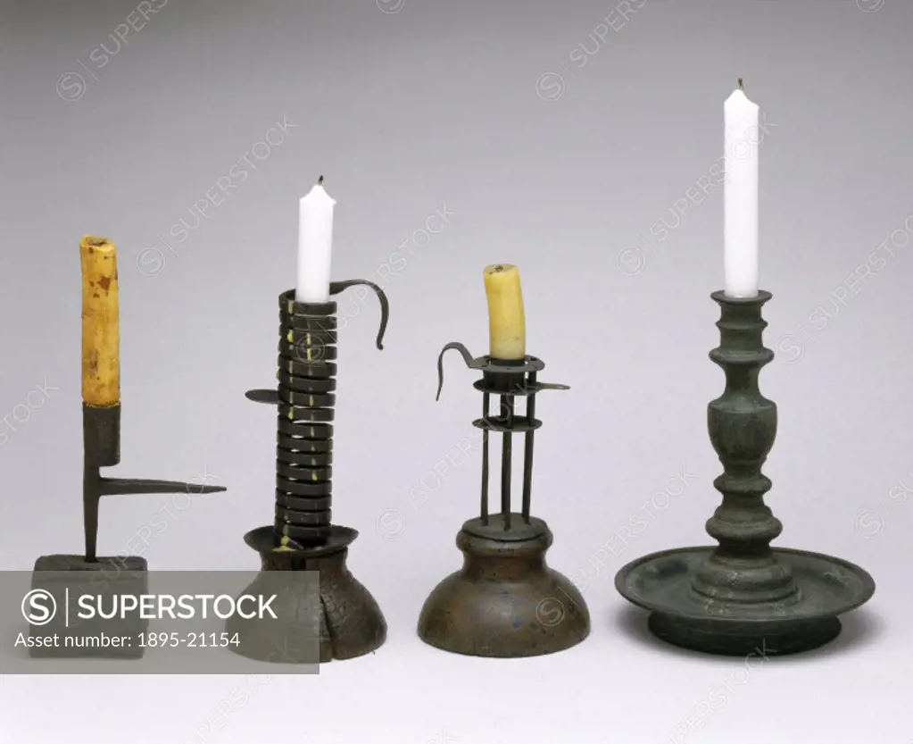 Four assorted candle holders, two having iron spikes at the side for sticking into a wall. They probably date from the 18th century.