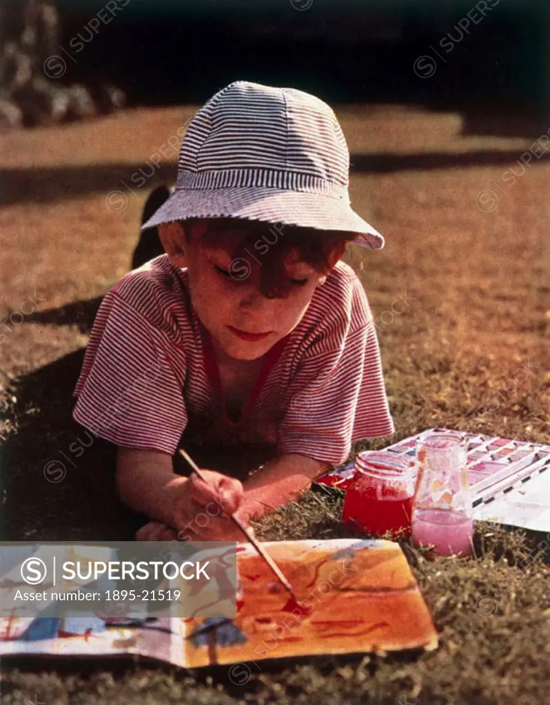 Boy painting in a sketchbook. This portrait is typical of a more casual post-war approach to colour photography.
