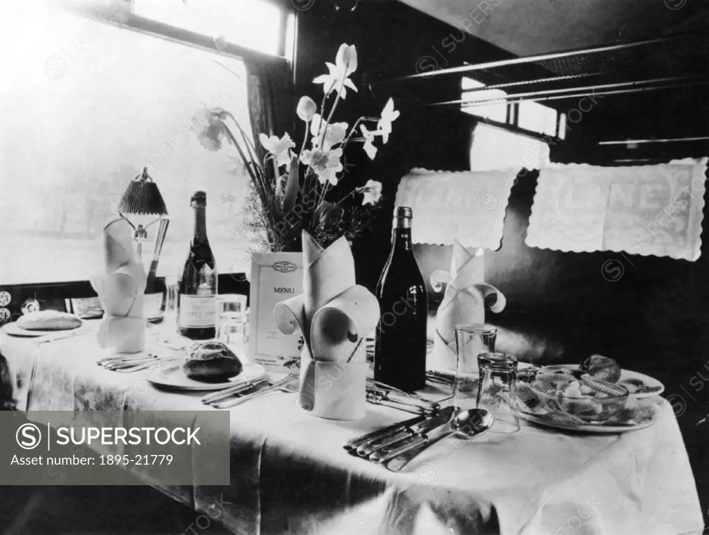 Table laid with champagne and wine in a London & North Eastern Railway (LNER) dining car.