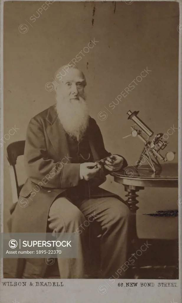 Carte de visite photograph by Wilson & Beadell of Charles Brooke (1804-1879) seated at a table on which stands a microscope. Brooke is holding the tur...