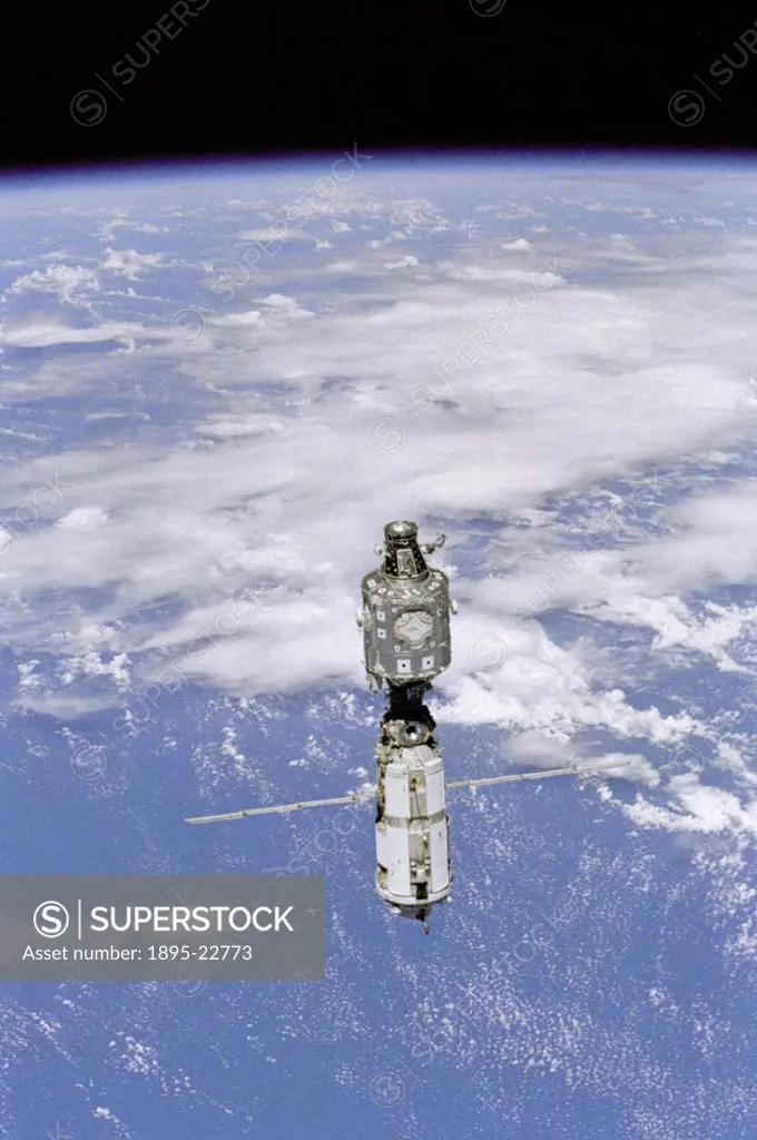 Backdropped against white clouds and blue ocean waters, the International Space Station (ISS) moves away from the Space Shuttle Discovery’. The US bu...
