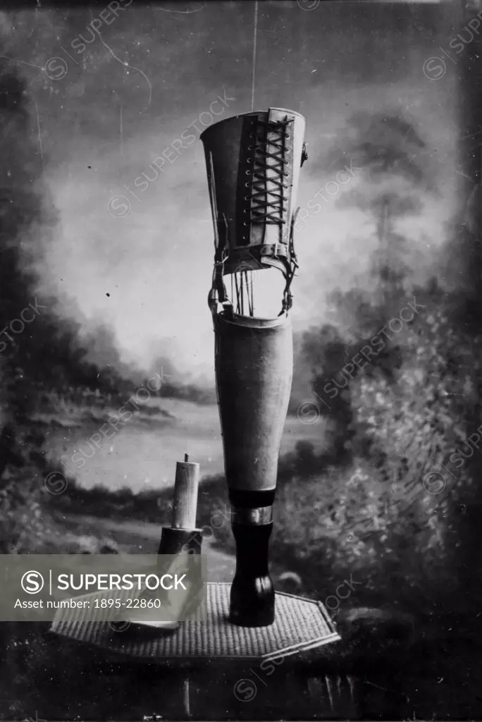Studio photograph of an artificial leg, terminating in a pylon, alongside an alternative show fitting.  The devices were manufactured by James Gilling...