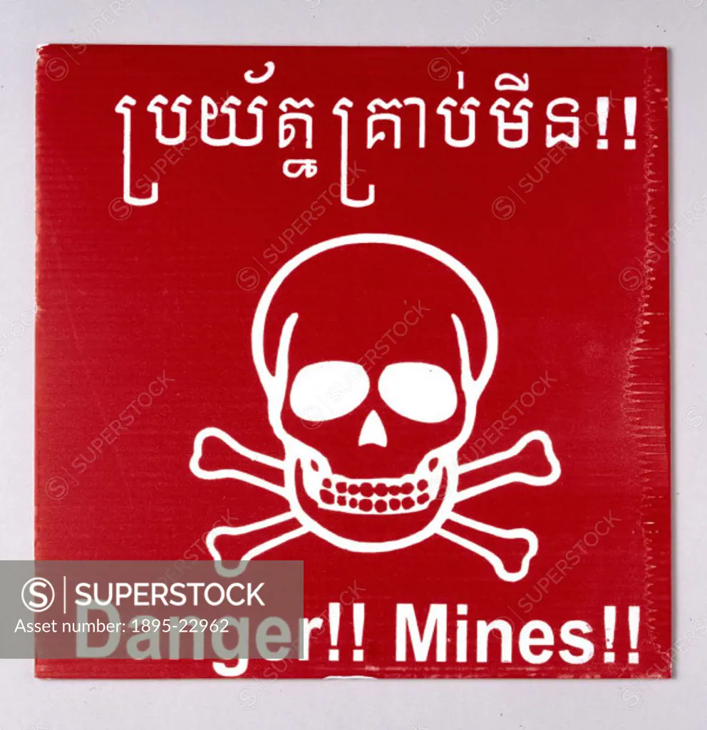 Plastic warning sign used to mark the presence of landmines in Cambodia, with red skull and crossbones design and message in English and Cambodian, pr...