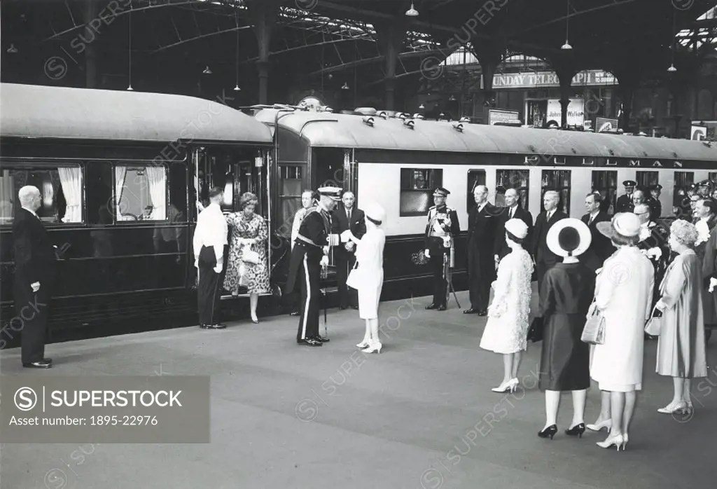 Queen Elizabeth II (1926-) being greeted in a railway station by a senior naval officer. Other dignitaries are present, such as Prime Minister Harold ...