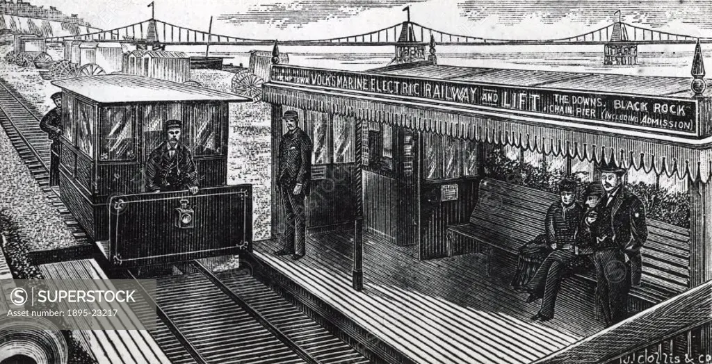 Woodcut showing an electric locomotive pulling into a small platform on Brighton beach, with a station guard and waiting passengers. This quarter mile...