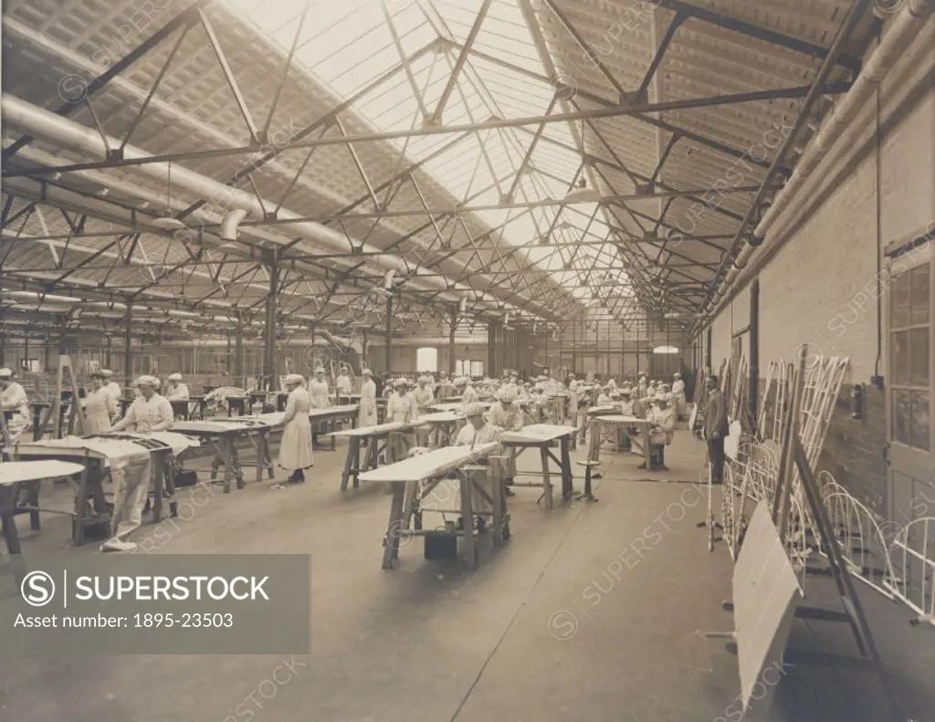 Sepia toned photograph showing women at work inside the National Aircraft Factory No 3. Three national aircraft factories were established by the Cuna...
