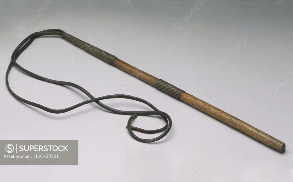Slave whip made of leather and wood with woven steel wire mounts.