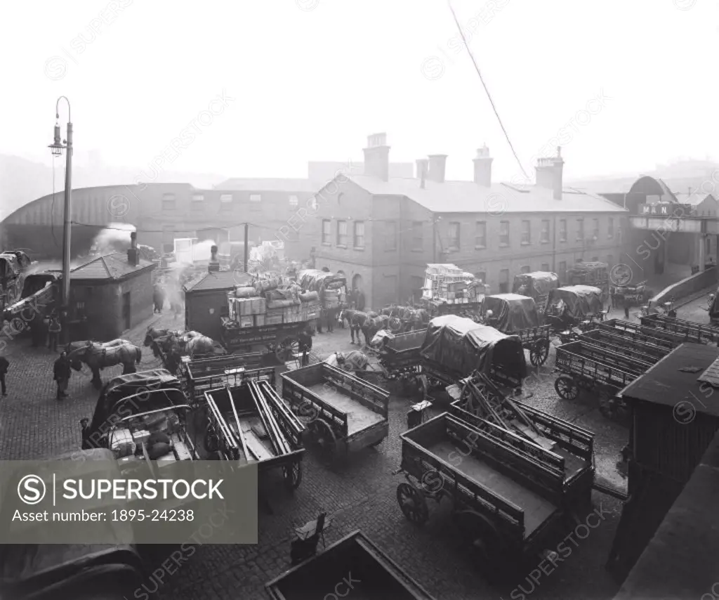 Photograph of the goods yard showing sheds, offices and waiting horses and carts. Paddington Station was the London terminus of the Great Western Rail...