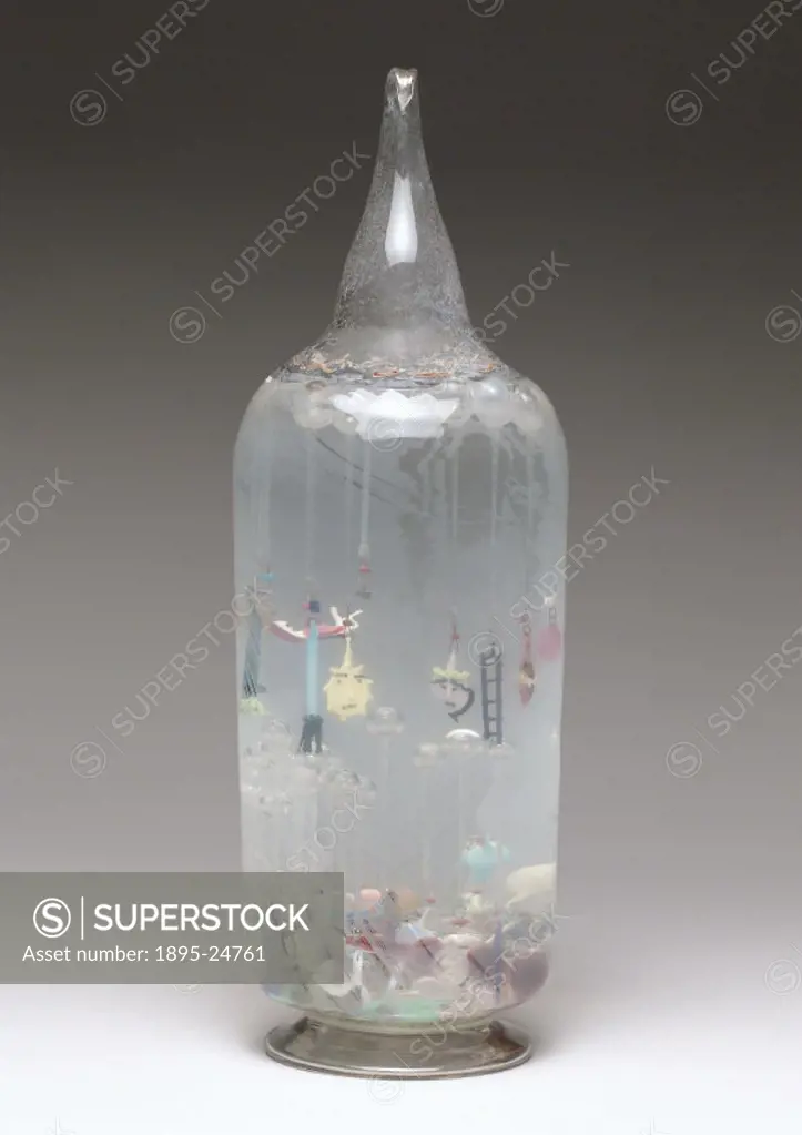 Large glass bottle containing glass amulets and religious symbols suspended from bulbs in holy water. From the De Mortillet collection in Liesse. An a...