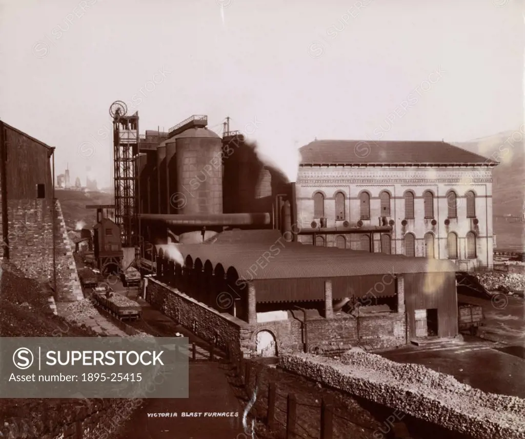 Photograph showing the exterior buildings of a Victoria blast furnace in an industrial landscape of South Wales.