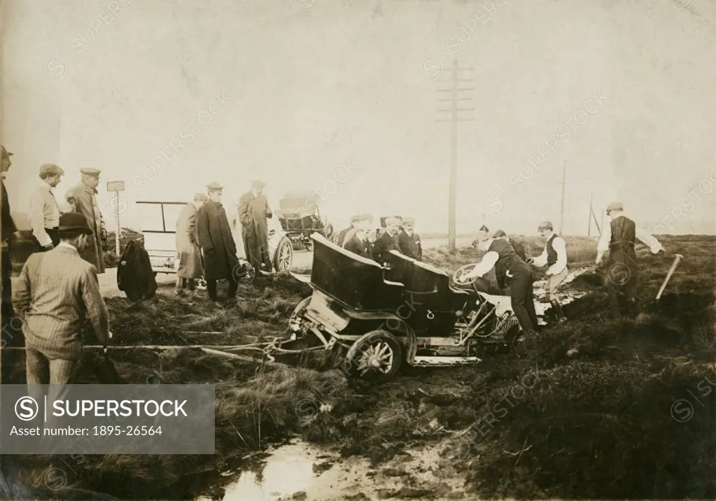 Photograph by H Wade. Onlookers gather around a car which has left the road during the hill climb organised by the Manchester Automobile Club on 5th O...