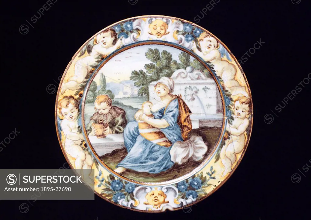 This plate depicts the scene of a family, the mother is breast feeding a baby, while a small child holds a drinking vessel. Earthenware is the earlies...