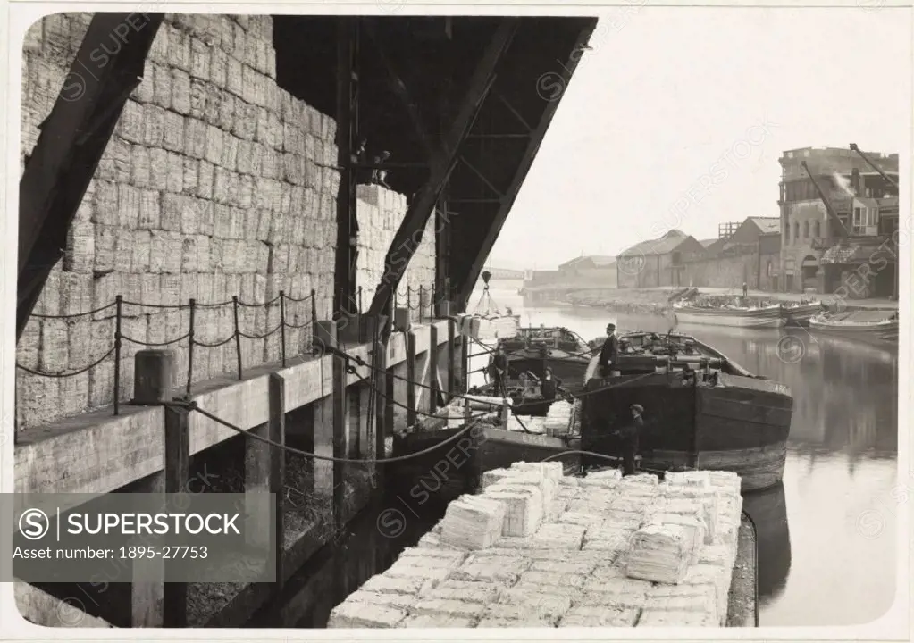 Offloading moist paper pulp from barges to pulpsheds, 1936.One of a series of 16 photographs taken of the processes and machinery involved in paper ma...