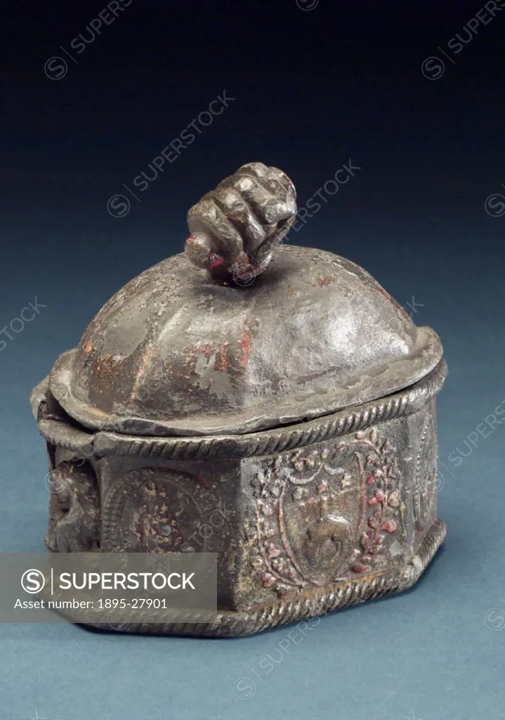 Octagonal shaped jar used for storing pipe tobacco with lead presser and detachable domed lid topped with a finial in the shape of a hand clutching a ...