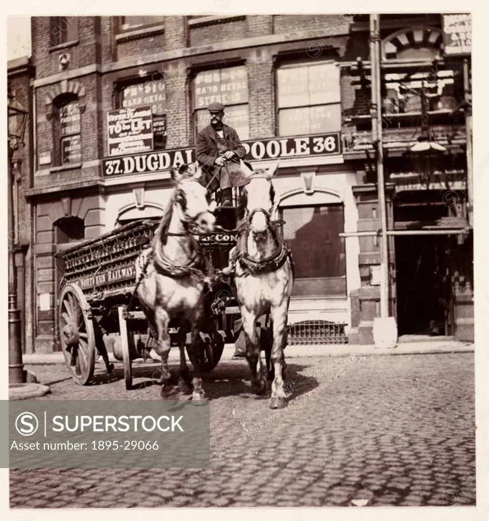 A photograph by George Davison 1854-1930 of a man driving a horse-drawn delivery wagon, probably in London, in about 1895.  The lettering on the sid...