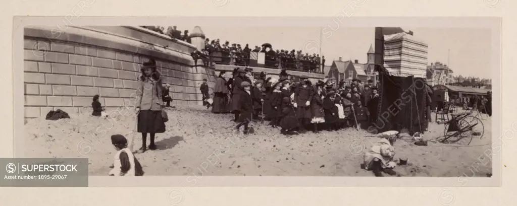 A panoramic photograph of the beach and promenade at Lowestoft, taken by George Davison 1854-1930 in about 1905.  A few children play in the foregro...