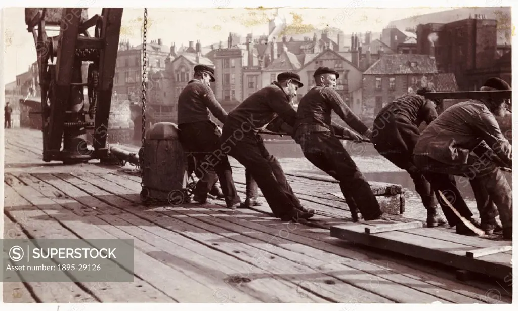 Photograph by Frank Meadow Sutcliffe (1853-1941) of men presumably hauling a boat in, taken using a No 3A Folding Pocket Kodak camera. On the left is ...