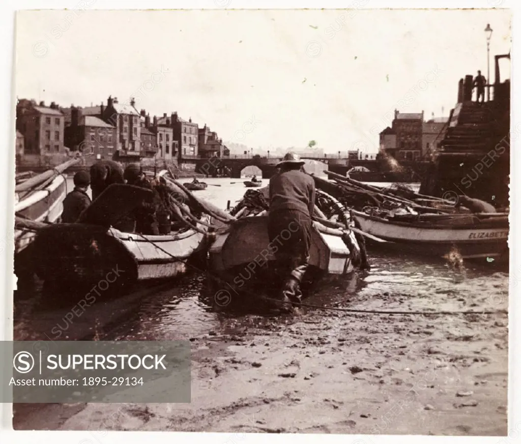 Photograph by Frank Meadow Sutcliffe (1853-1941) using a No 2 Plico Kodak camera. The row of coble boats is moored at the foot of the harbourside step...