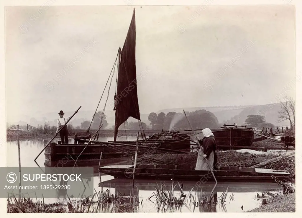 A photograph titled ´The Ferry´, taken by Colonel Joseph Gale (c 1835-1906), in 1890, of riverboats.  A woman is polling a flat-bottomed punt out to a...