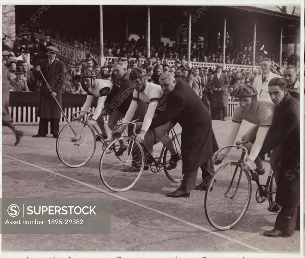 A snapshot photograph of cyclists lined up for the start of a sprint race at Herne Hill Stadium, London, taken by an unknown photographer in 1937.  Cy...