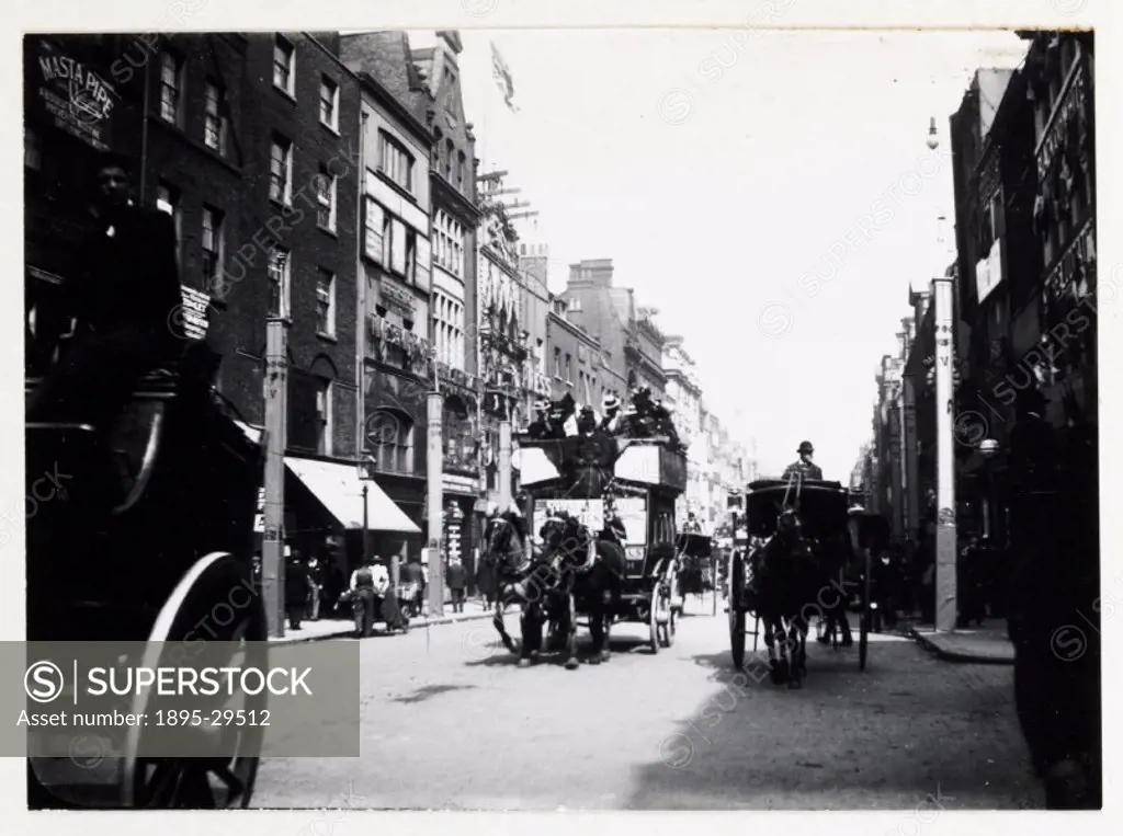 A snapshot photograph of Fleet Street, London, taken by an unknown photographer in about 1900.  The street is busy with Hansom cabs and a horse-drawn ...