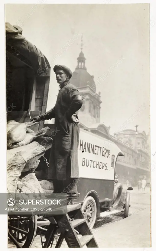 A snapshot photograph of Smithfield Market, London, taken by an unknown photographer in 1915. A man unloads meat from the back of a butcher´s van.  Me...