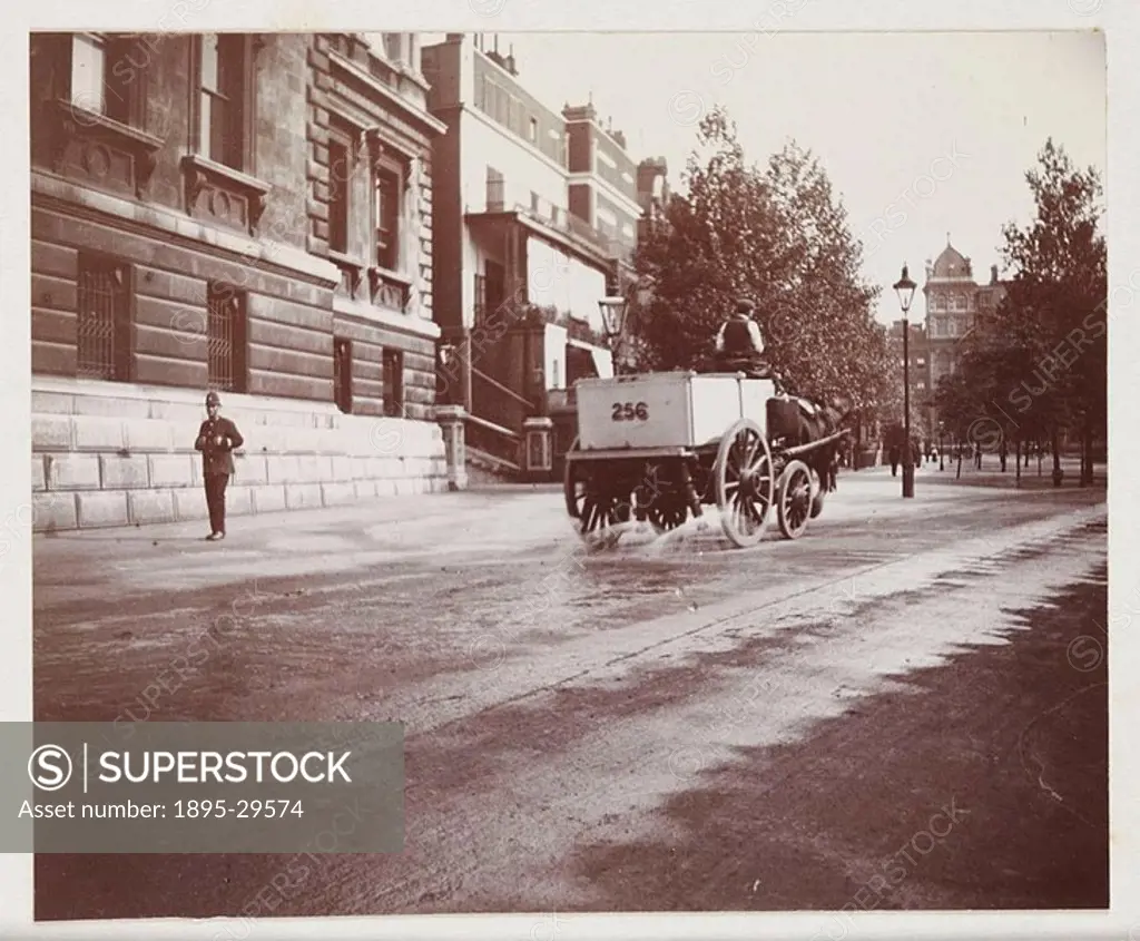 A snapshot photograph of a cart spraying water on a road in London, taken by an unknown photographer in about 1912  Originally a shooting term, ´snaps...