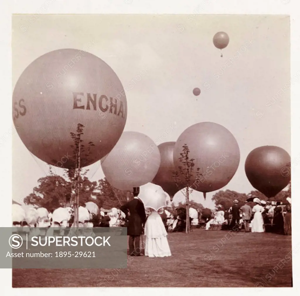 A snapshot photograph of a number of balloons rising into the sky as a crowd watch below, taken by an unknown photographer, camera, on 30 May, 1908, u...