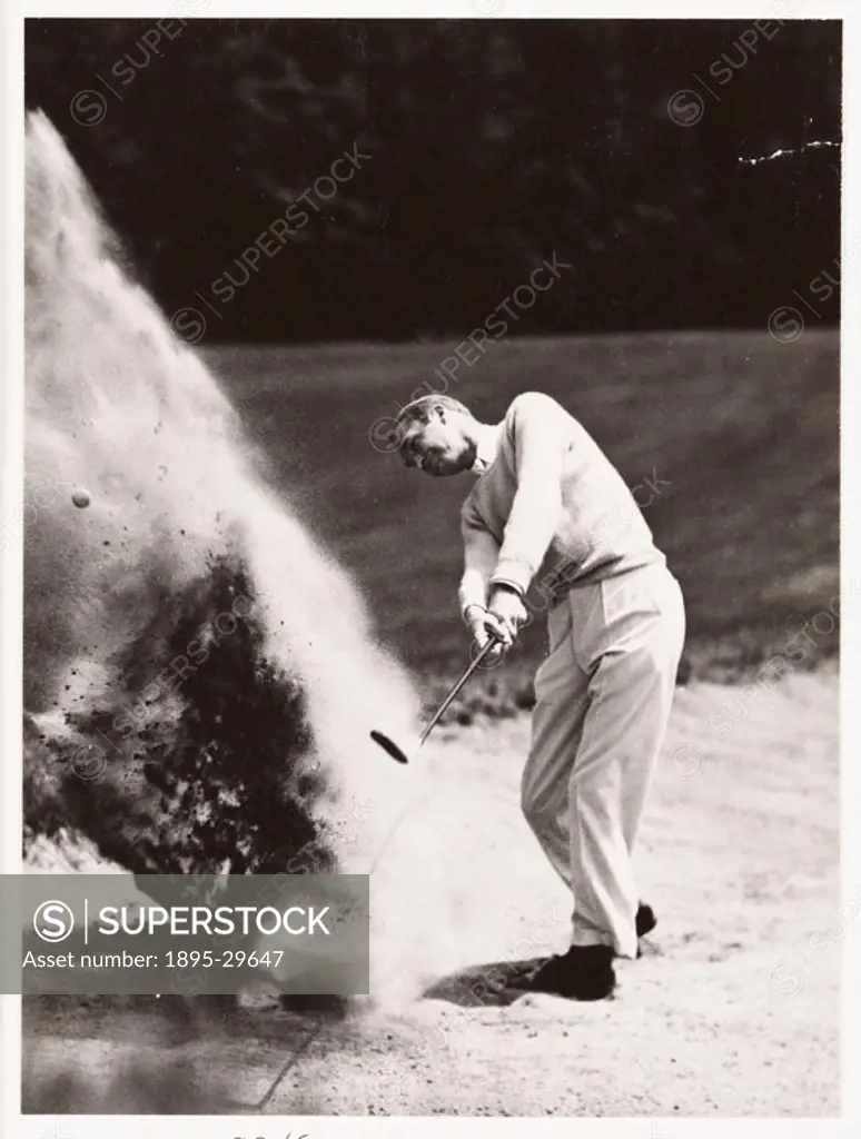 A photograph of a golfer playing a shot from a bunker, taken by an unknown photographer.
