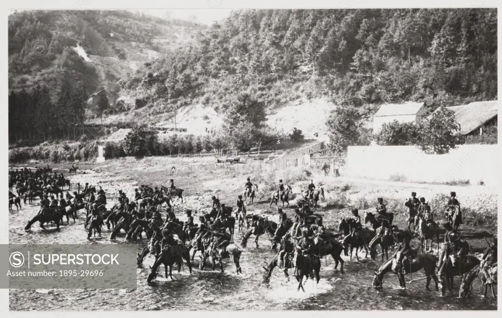 A snapshot photograph of Russian cavalry watering their horses in a river, taken by an unknown photographer in about 1918.  Originally a shooting term...