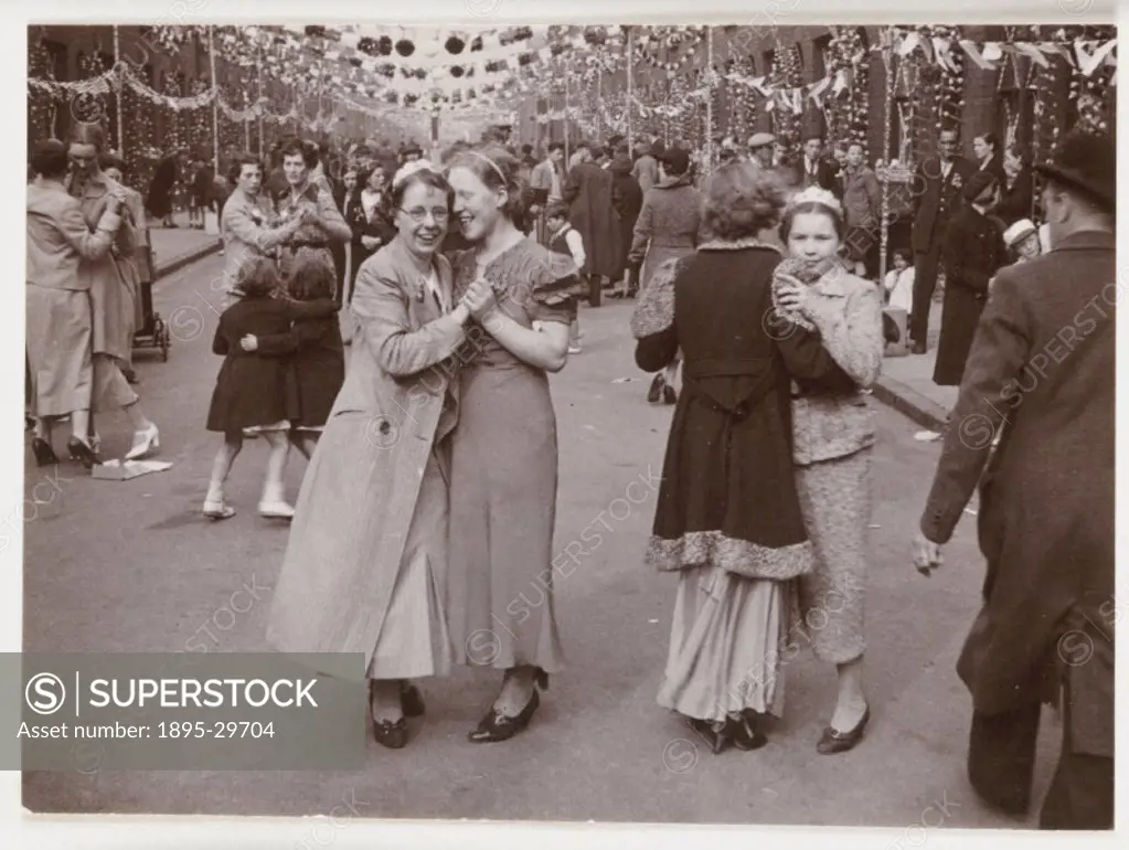 A snapshot photograph of people dancing in the streets of Bootle, Liverpool, taken by an unknown photographer in about 1937. This street party is prob...