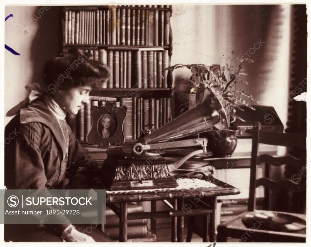 A snapshot photograph of a woman listening to a gramophone, taken by an unknown photographer in about 1905.  Originally a shooting term, the word ´sna...