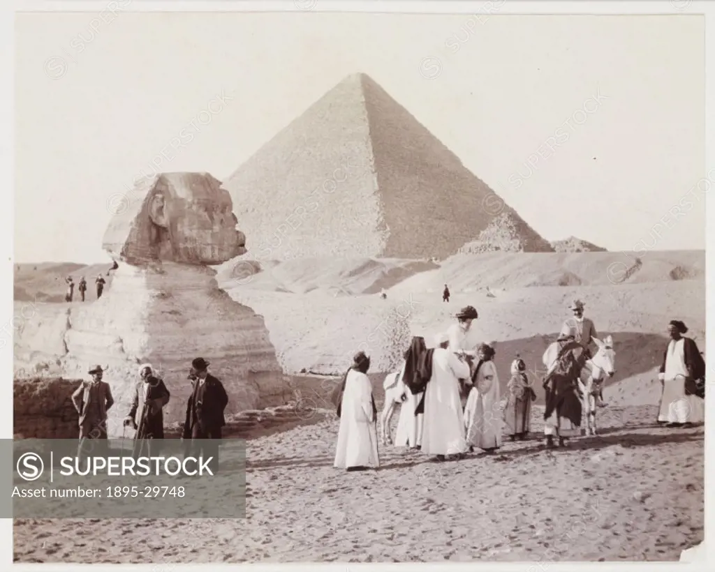 A snapshot photograph of  tourists at the Sphinx, Egypt, taken by an unknown photographer in about 1905. A group of European tourists, accompanied by ...