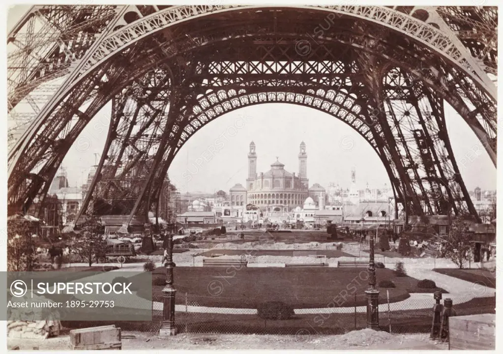 A snapshot photograph of the Trocadero and Paris Exhibition of 1900, seen through the legs of the Eiffel Tower, taken by an unknown photographer in ab...