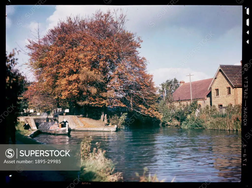 A Kodachrome colour photograph of a narrow boat entering a canal lock, taken by an unknown photographer in about 1945.  This photograph is a Kodachrom...