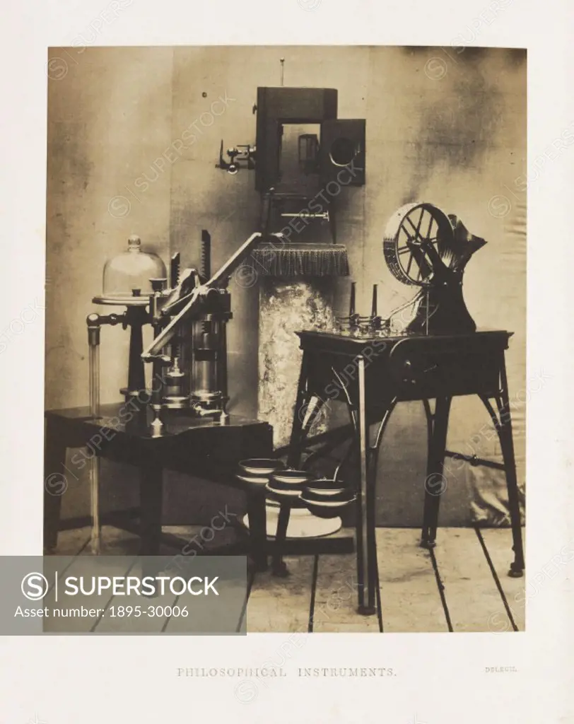 A photograph of various philosophical instruments, including balances, a coin-weighing machine and an air-pump, manufactured by Deleuil, shown at the ...