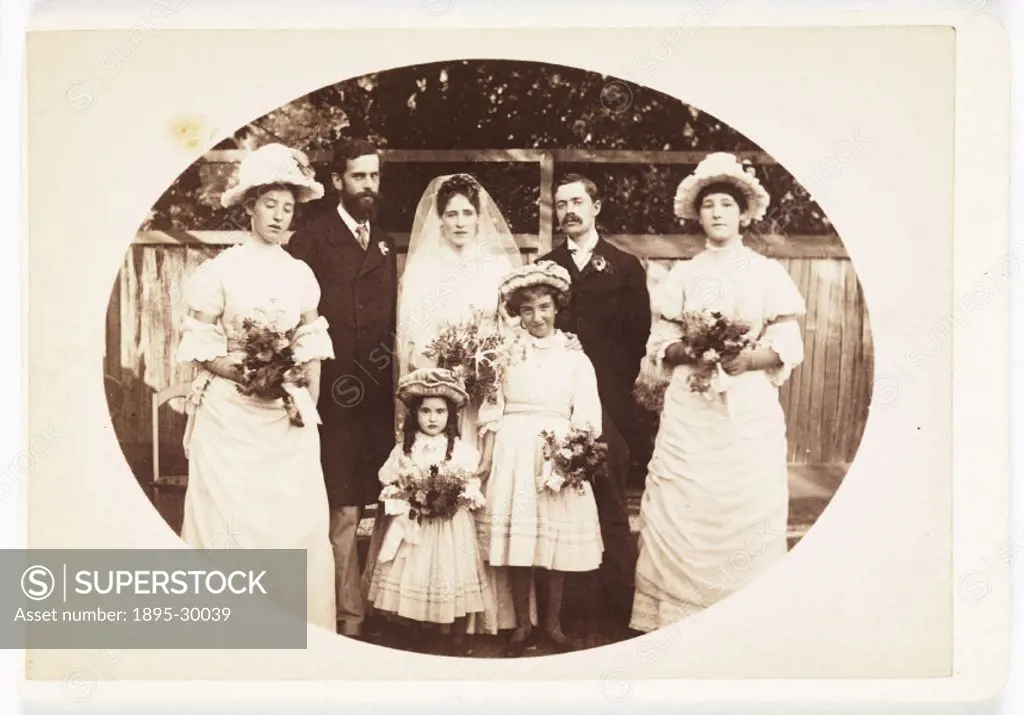 A cabinet card wedding group photograph, taken by a unknown photographer in about 1900.  Cabinet cards are photographs mounted on stiff pieces of card...