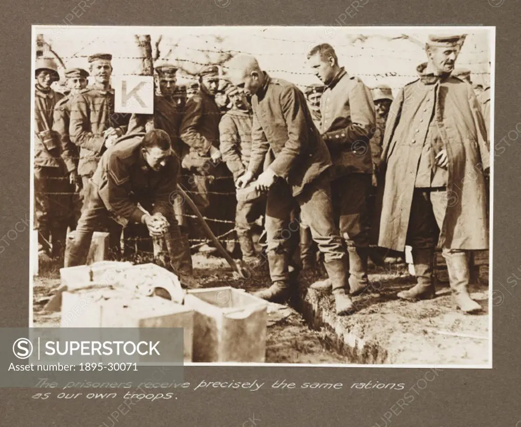 A photograph of a group of German prisoners waiting for food, taken by an unknown photographer in about 1917, during World War One.  This photograph i...