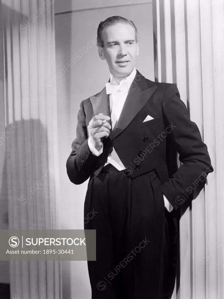 A photograph of a man in evening dress smoking a cigarette, aken by Photographic Advertising Limited in 1950.  Photographic Advertising Limited was fo...