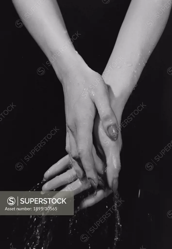 A photograph of a woman´s hands being washed in water, taken by Photographic Advertising Limited in 1955.  Photographic Advertising Limited was founde...