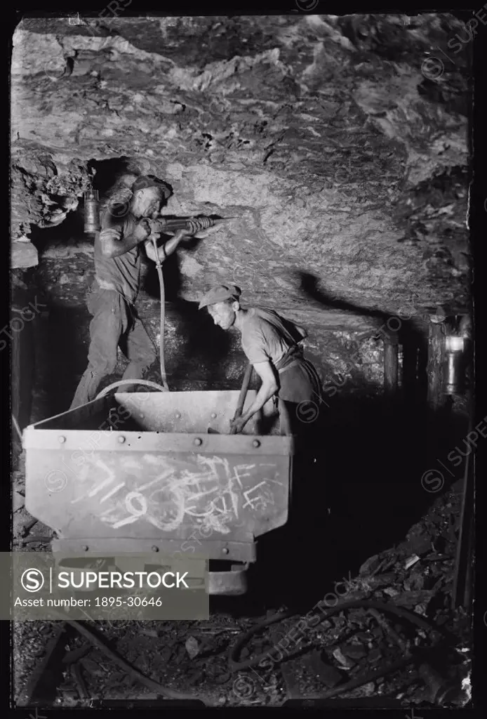 Taken by an unknown photographer for the Daily Herald newspaper in June 1931. One miner cuts the coal from the rock with a pneumatic drill. His partne...