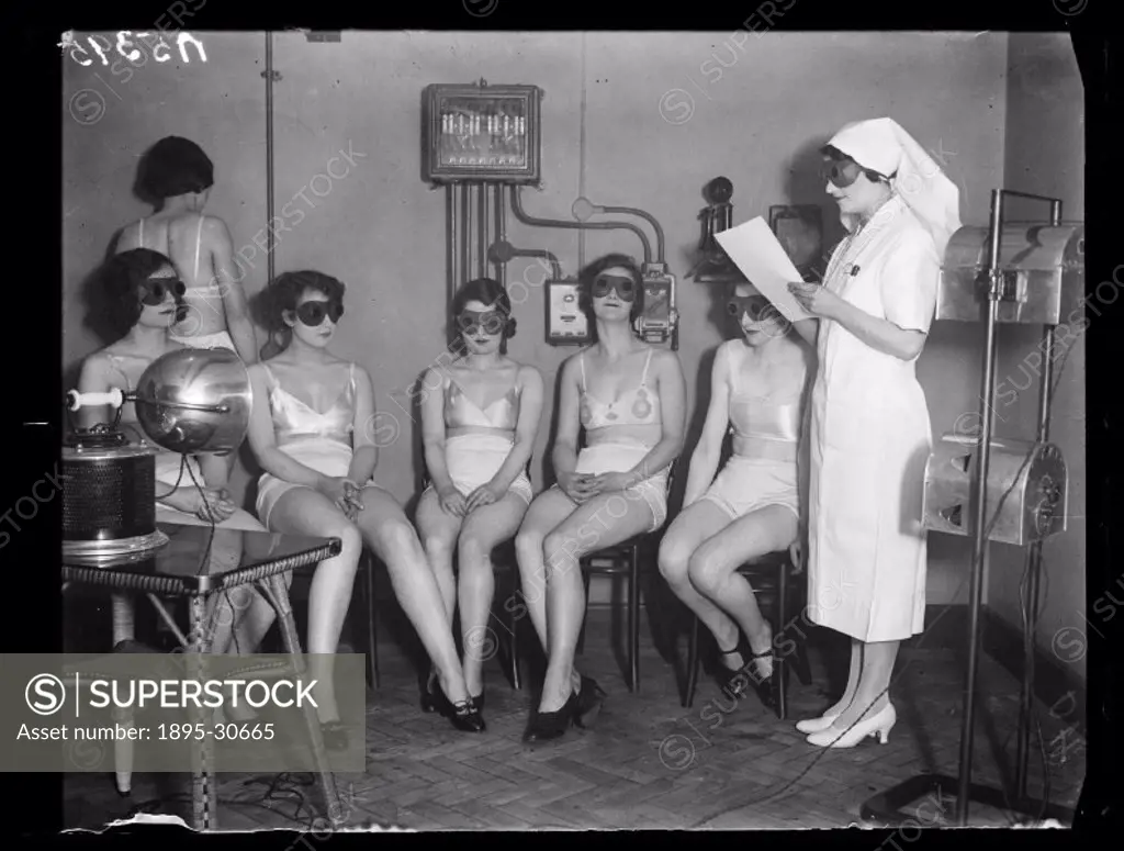 A photograph of women receiving sunray ´treatment´, taken by Cardew for the Daily Herald newspaper on 20 February, 1932. These women, all Metropole Ci...