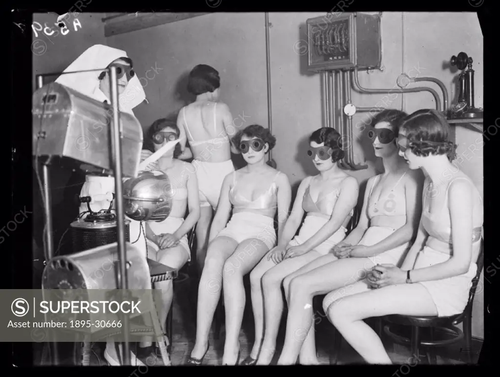 A photograph of women receiving sunray ´treatment´, taken by Cardew for the Daily Herald newspaper on 20 February, 1932. These women, all Metropole Ci...