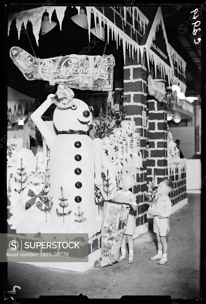A photograph of a giant snowman. The snowman was part of a display of Christmas products shown at the Chocolate and Confectionery Exhibition at London...