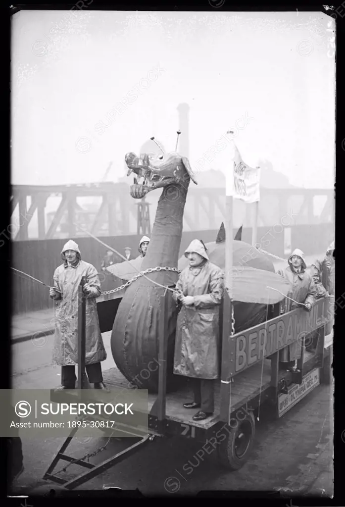 A photograph of a Loch Ness Monster model being taken by trailer to Bertram Mills Circus, taken by James Jarche (1891-1965) for the Daily Herald newsp...