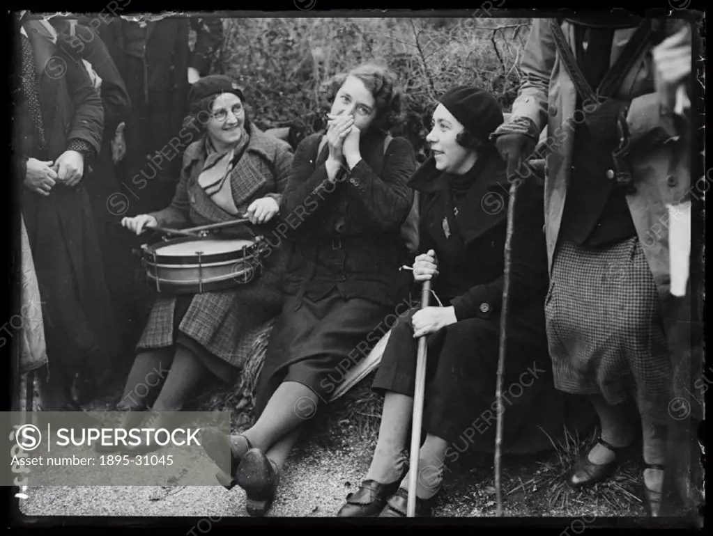A photograph of a group of female hunger marchers resting near St Albans, Hertfordshire, taken by Tomlin for the Daily Herald newspaper on 4 November,...