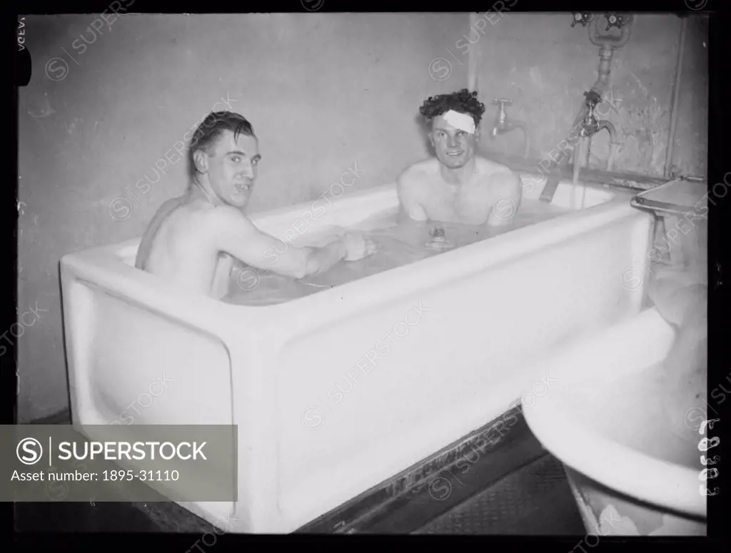 A photograph of two footballers bathing together after a match, taken by Edward Malindine for the Daily Herald newspaper on 16 February, 1938. The two...